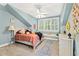 Charming bedroom with light blue walls, a comfy bed, and a window seat at 117 N Cove Dr, Peachtree City, GA 30269