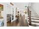 Bright entryway with hardwood floors, staircase, and view into living area at 117 N Cove Dr, Peachtree City, GA 30269