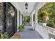 Front porch with black door and hanging egg chair at 117 N Cove Dr, Peachtree City, GA 30269