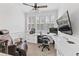 Spacious home office with built-in desk, large TV, and comfortable recliner at 117 N Cove Dr, Peachtree City, GA 30269