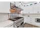 Bright kitchen with professional range and white cabinetry at 117 N Cove Dr, Peachtree City, GA 30269