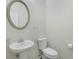 Clean bathroom with pedestal sink, toilet, and oval mirror at 1762 Caswell Pkwy # 33, Marietta, GA 30060