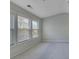 Bedroom featuring three windows and neutral colored carpeting and walls at 1762 Caswell Pkwy # 33, Marietta, GA 30060