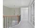 Upstairs hallway with chandelier, neutral paint, and carpet at 1762 Caswell Pkwy # 33, Marietta, GA 30060