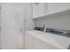 Bright laundry room with washer, dryer, and built-in shelving at 1762 Caswell Pkwy # 33, Marietta, GA 30060
