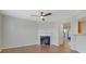 Open living room with fireplace, hardwood floors and views to kitchen and stairs at 1762 Caswell Pkwy # 33, Marietta, GA 30060