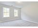 Spacious bedroom with two large windows and plush carpeting at 221 Admor Ln, Acworth, GA 30102