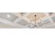 Coffered ceiling with a modern chandelier, adds architectural interest at 941 Keystone Dr, Woodstock, GA 30188