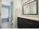 Bathroom with dark vanity, granite countertop, and a large mirror at 2810 Stillwater Park Dr, Marietta, GA 30066