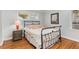 Bedroom with metal bed frame, hardwood floors and a neutral color scheme at 3027 Saint Annes Nw Ln, Atlanta, GA 30327