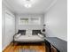 Cozy bedroom with daybed, built-in desk, and hardwood floors at 3027 Saint Annes Nw Ln, Atlanta, GA 30327