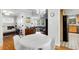 Dining room with white table and chairs, hardwood floors, and views into other rooms at 3027 Saint Annes Nw Ln, Atlanta, GA 30327