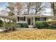 House exterior showcasing a covered porch and well-maintained lawn at 3027 Saint Annes Nw Ln, Atlanta, GA 30327