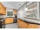 Bright kitchen features light wood cabinets, granite countertops, and a view to backyard at 3027 Saint Annes Nw Ln, Atlanta, GA 30327