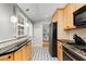 Kitchen with granite counters, stainless steel appliances, and light wood cabinets at 3027 Saint Annes Nw Ln, Atlanta, GA 30327
