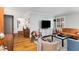 Bright living room with hardwood floors, comfy seating, and a large TV at 3027 Saint Annes Nw Ln, Atlanta, GA 30327