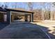 Covered carport with seating area and wooded views at 1126 Wedgefield Dr, Marietta, GA 30064