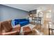 Living room features hardwood floors, a blue couch, and a brown leather chair at 2232 Dunseath Nw Ave # 309, Atlanta, GA 30318