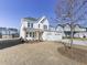 Two story white brick home with three car garage and partially visible landscaping at 2144 Suncrest Pt, Marietta, GA 30064