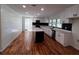 Modern kitchen with white cabinets, hardwood floors, and island at 428 Nebo Rd, Dallas, GA 30157