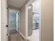 Hallway view of a modern home with grey flooring and access to bathroom and kitchen at 700 Wilson Mill Sw Rd, Atlanta, GA 30331