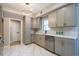 Updated kitchen featuring gray cabinets, stainless steel appliances, and marble-look flooring at 700 Wilson Mill Sw Rd, Atlanta, GA 30331