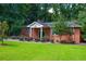 Brick community building with landscaping and green lawn area at 723 Campbell Cir, Hapeville, GA 30354
