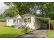 White brick ranch house with blue door, carport, and well-manicured lawn at 723 Campbell Cir, Hapeville, GA 30354