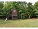 Playset, treehouse, and swings create a fun backyard at 12551 Alcovy Rd, Covington, GA 30014