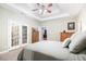 Main bedroom with stained glass doors and ceiling fan at 12551 Alcovy Rd, Covington, GA 30014