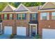 Brick front exterior of townhome with two-car garage at 3927 Snipes Ct, Lilburn, GA 30047