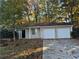 Ranch home with two-car garage and mature trees at 5464 Martins Crossing Rd, Stone Mountain, GA 30088