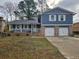 Updated two-story home with a new paint job, two-car garage and a modern front porch at 2314 Emerald Springs Dr, Decatur, GA 30035