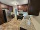 Updated kitchen with dark wood cabinets and granite countertops at 2314 Emerald Springs Dr, Decatur, GA 30035