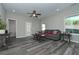 Gathering room with gray sofa, wood floors, and a view of the backyard at 804 Trestle Creek Ct, Temple, GA 30179