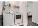 Bright laundry room with washer, dryer, and shelving at 825 Angora Aly, Scottdale, GA 30079