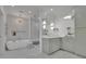 Luxurious bathroom featuring a soaking tub, walk-in shower, and marble tile at 115 17Th Ne St, Atlanta, GA 30309