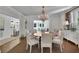 Formal dining room with a large round table, chandelier, and hardwood floors at 115 17Th Ne St, Atlanta, GA 30309