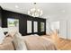 Main bedroom with hardwood floors and a statement wall at 1129 Victory Sw Dr, Atlanta, GA 30310