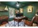 Elegant home office with dark green walls, wood desk, and comfortable leather chair at 1461 Milford N Ct, Marietta, GA 30008