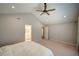 Spacious bedroom with high ceiling, ceiling fan, and ensuite bathroom access at 179 Wallnut Hall Cir, Woodstock, GA 30189