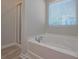 Relaxing bathroom with soaking tub and window at 509 Ajo Way, Dallas, GA 30157