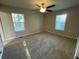 Bedroom with ceiling fan, carpet, and two windows at 309 Hemphill School Nw Rd, Atlanta, GA 30331