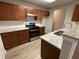 Updated kitchen featuring granite countertops and wood cabinets at 309 Hemphill School Nw Rd, Atlanta, GA 30331