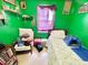 Small bedroom with a single bed, green walls, and window at 1251 Lorenzo Dr, Atlanta, GA 30310