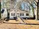 White house with ramp access, situated on a lot with mature trees at 1251 Lorenzo Dr, Atlanta, GA 30310