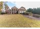 Brick home on a sloping lot with landscaping and a two-car garage at 110 Robinwood Ct, Fayetteville, GA 30214