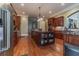 Large kitchen with island, granite counters, and dark wood cabinets at 110 Robinwood Ct, Fayetteville, GA 30214