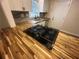 Modern kitchen with butcher block countertop and gas cooktop at 1303 Rocksprings St, Forest Park, GA 30297