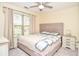 Spacious bedroom with a queen bed, large window, and ceiling fan at 6161 Thorncrest Dr, Tucker, GA 30084